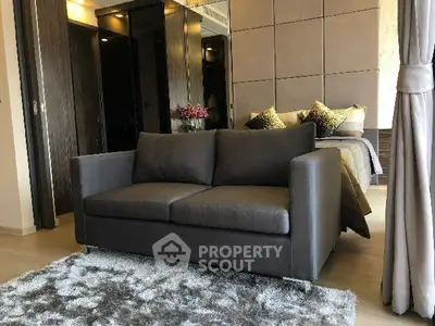 Luxurious bedroom with stylish sofa and plush carpet