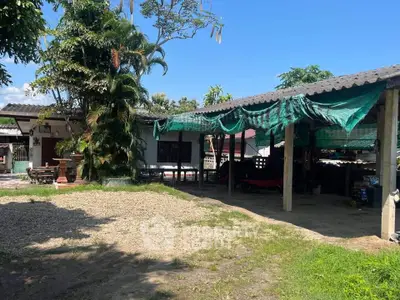 Charming rustic property with spacious outdoor area and lush greenery, perfect for relaxation and gatherings.