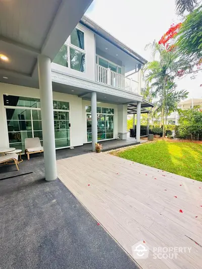 Stunning modern home with spacious garden and elegant balcony, perfect for luxurious living.