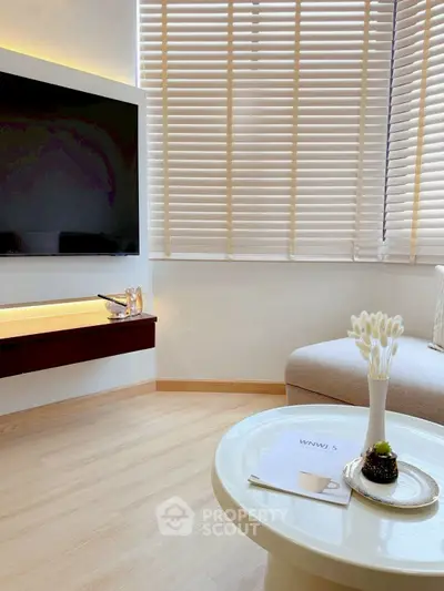 Modern living room with sleek TV setup and cozy seating area