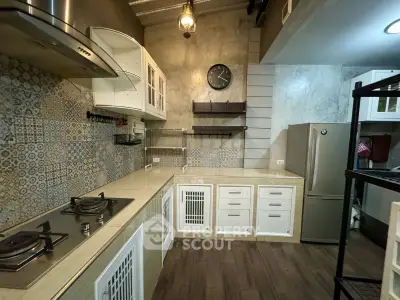 Chic industrial-style kitchen with modern appliances and unique tile backsplash.