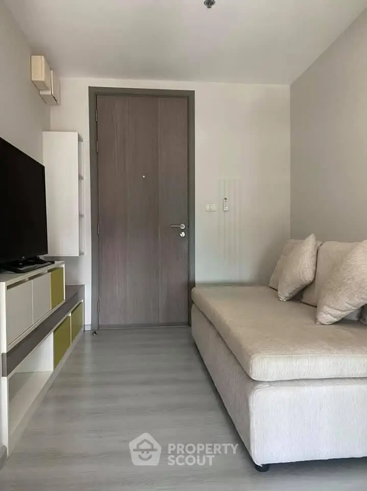 Cozy living room with modern sofa and TV unit, perfect for relaxation.