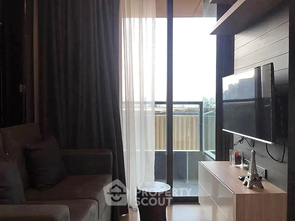 Modern living room with balcony view and sleek TV setup