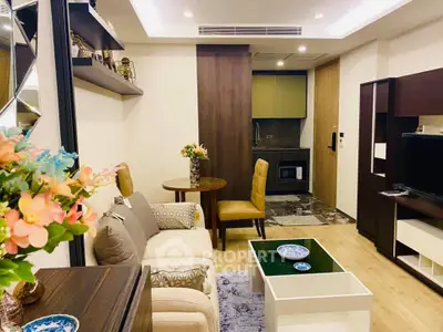Cozy living room with modern decor and open kitchen layout in a stylish apartment.