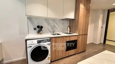 Modern kitchen with integrated appliances and sleek wooden cabinetry