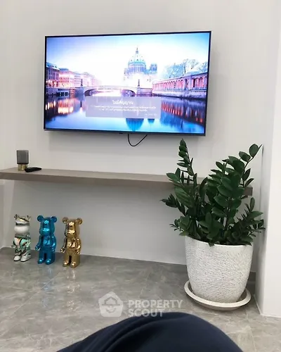 Modern living room with wall-mounted TV and stylish decor