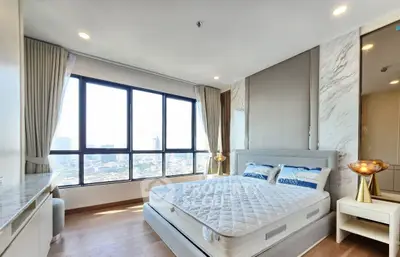 Luxurious bedroom with panoramic city view and elegant decor