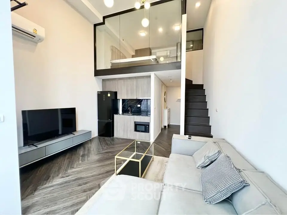 Modern loft-style living room with mezzanine, sleek furniture, and elegant design.