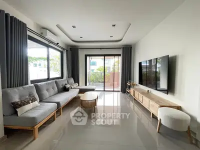 Spacious modern living room with large windows and stylish furniture