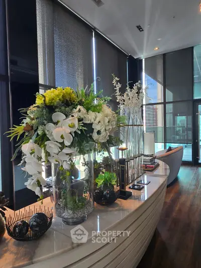 Luxurious modern living room with elegant floral arrangements and sleek decor