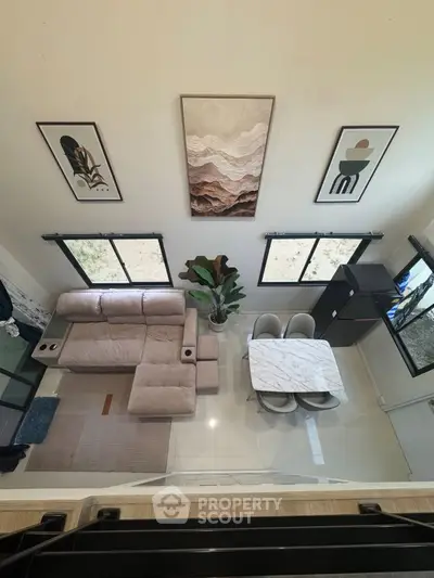 Modern living room with stylish decor and dining area, featuring a cozy sofa and elegant marble table.