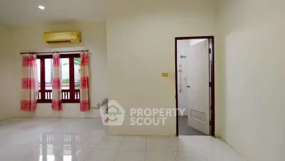 Spacious empty room with air conditioning and tiled floor, ready for customization.