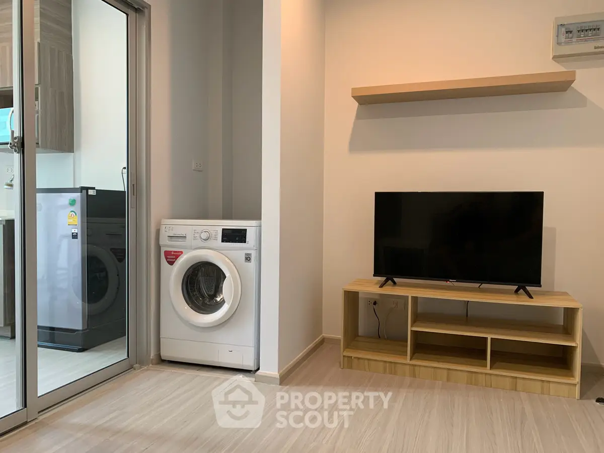 Modern living room with washing machine and TV, open layout design