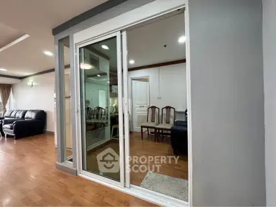 Spacious living room with sliding glass doors and wooden flooring