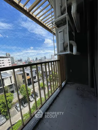 Urban balcony with city view and safety netting, ideal for enjoying skyline vistas.