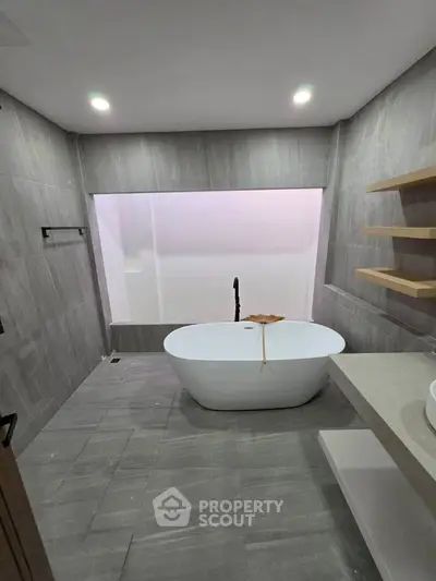 Luxurious modern bathroom with freestanding bathtub and elegant gray tiles