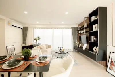 Spacious modern living room with elegant decor and open dining area, perfect for entertaining.