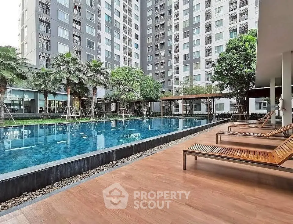Luxurious apartment complex with a stunning outdoor pool and modern amenities.