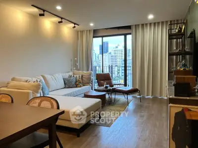 Modern living room with city view, stylish furniture, and natural light.