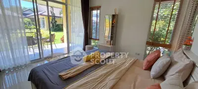 Spacious bedroom with balcony access and garden view in modern home