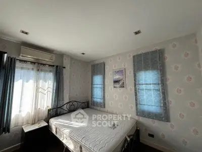 Cozy bedroom with floral wallpaper and natural light