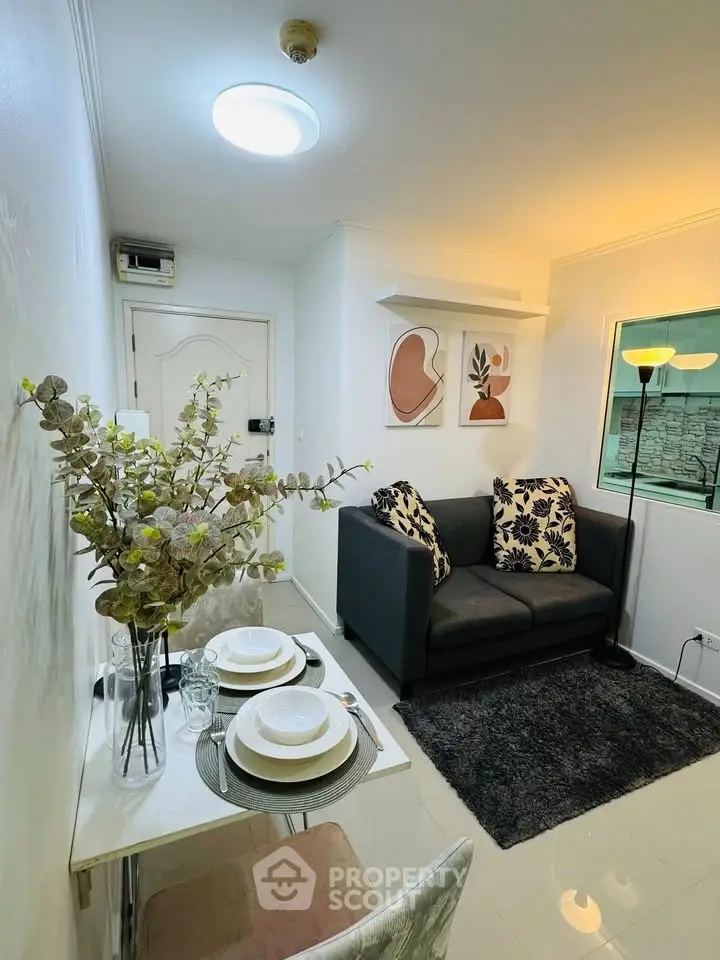 Cozy living room with modern decor and dining area in a compact apartment setting.