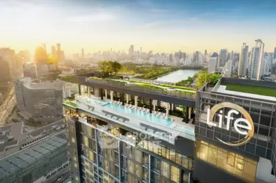 Luxurious high-rise building with rooftop pool and stunning city skyline view.
