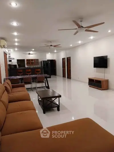 Spacious modern living room with open kitchen and stylish furnishings