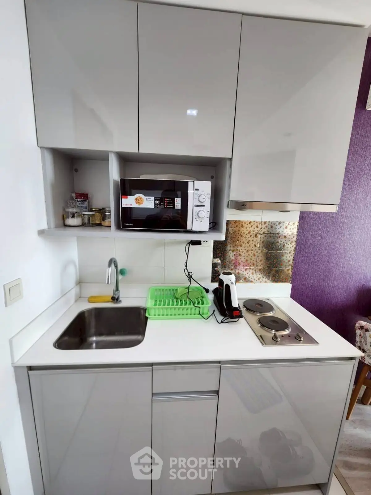 Modern compact kitchen with sleek cabinets and appliances