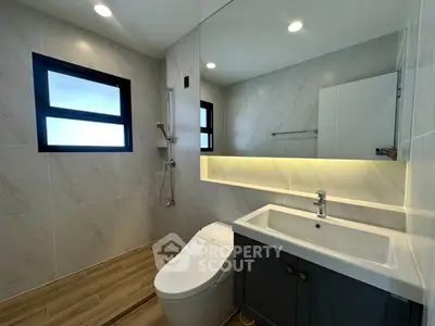 Modern bathroom with sleek fixtures and large mirror