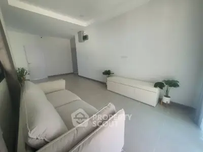 Spacious minimalist living room with modern sofa and sleek decor