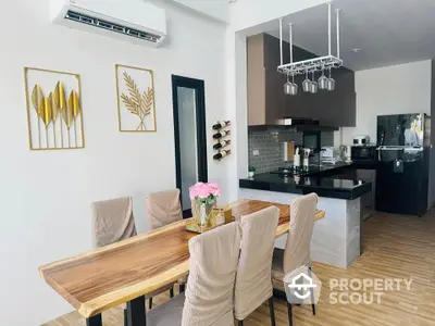 Modern dining area with stylish wooden table and sleek kitchen design