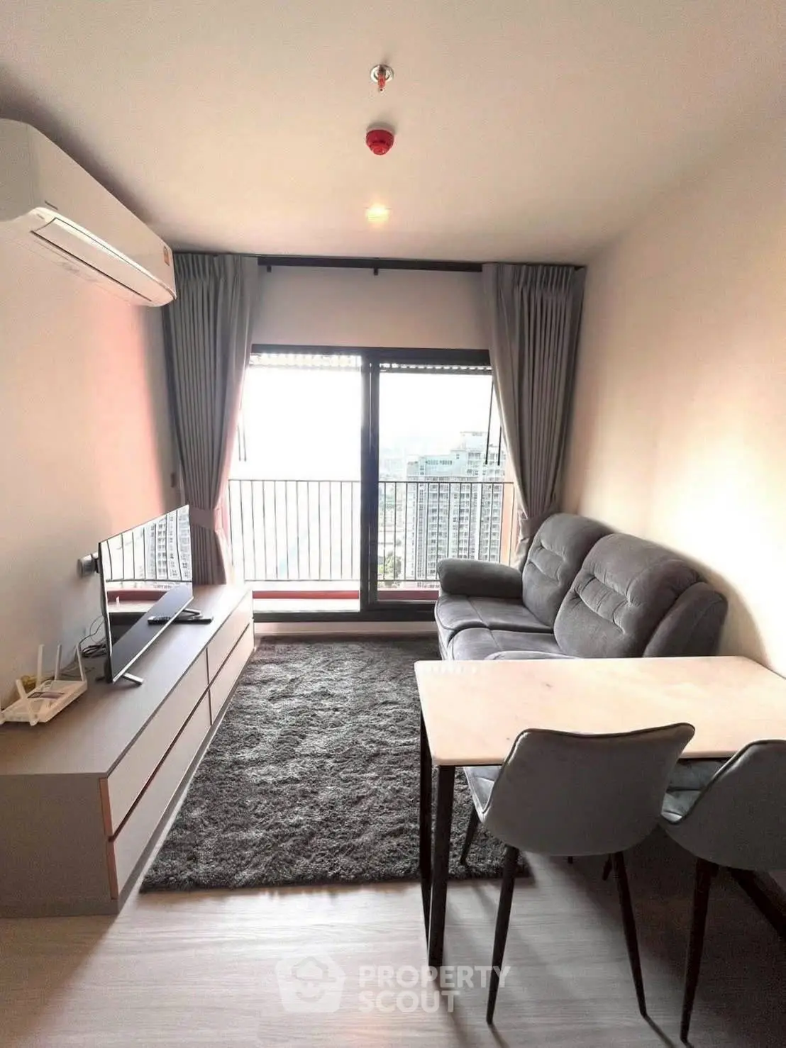 Modern living room with balcony view in high-rise apartment