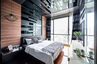 Luxurious modern bedroom with floor-to-ceiling windows and stunning city view
