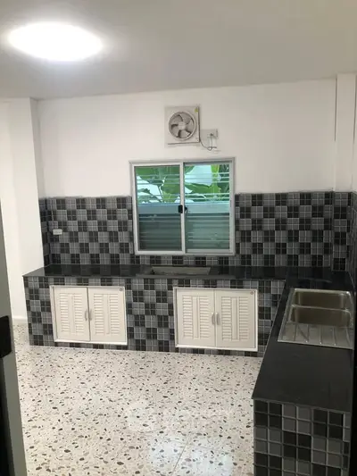 Modern kitchen with tiled backsplash and stainless steel sink