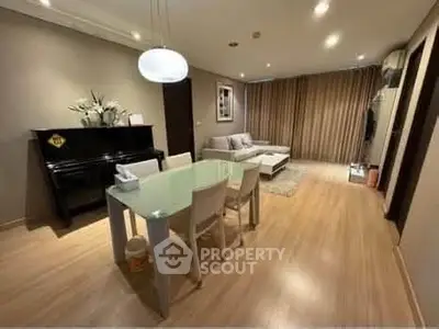 Spacious living room with modern decor and elegant dining area, perfect for entertaining guests.