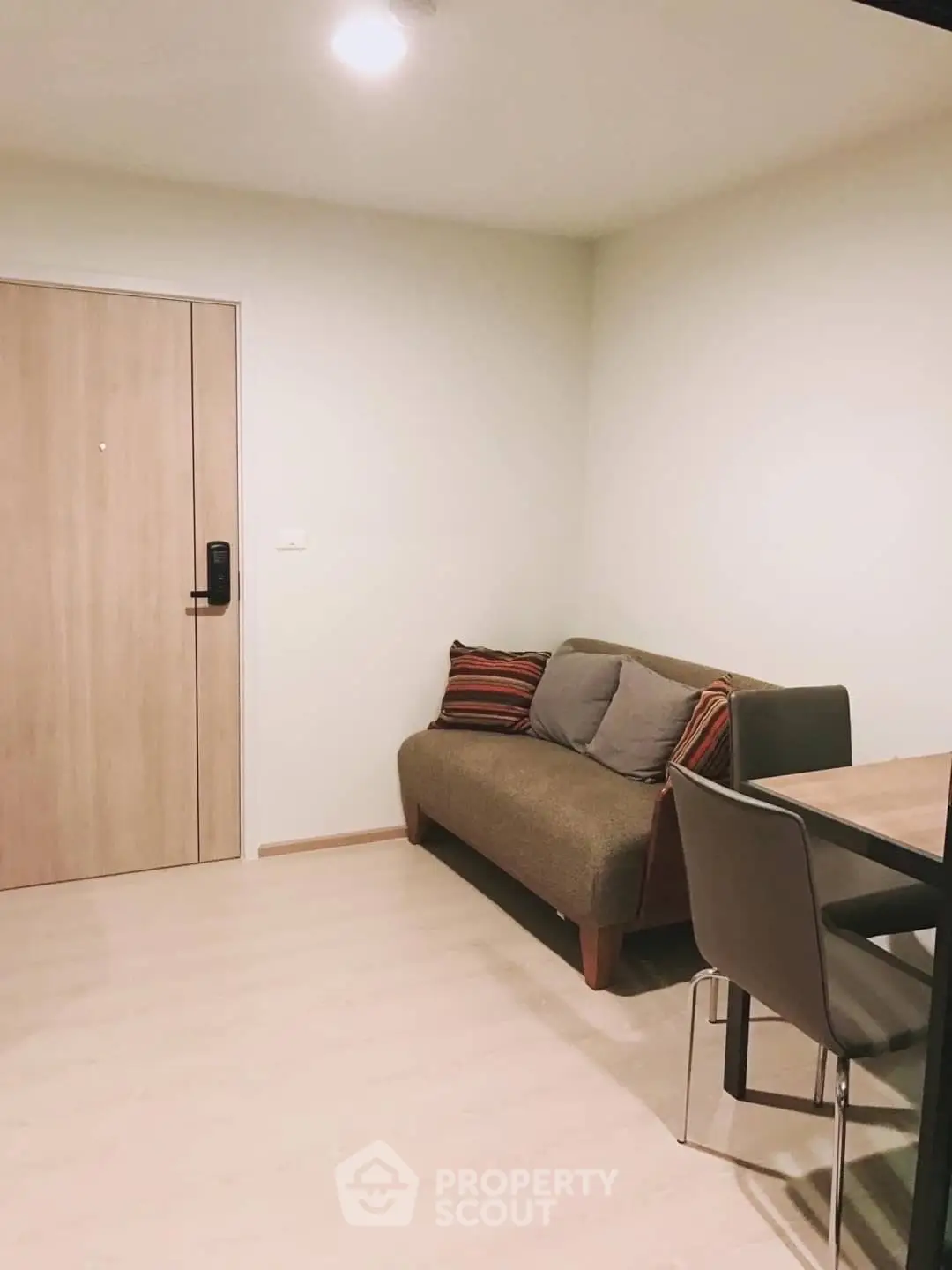 Cozy living room with modern sofa and dining area in stylish apartment.