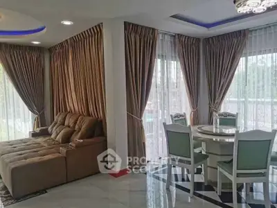 Spacious living room with elegant curtains and dining area, featuring modern furniture and ample natural light.