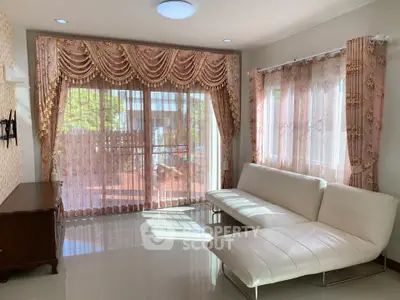 Elegant living room with luxurious curtains and modern white sofas