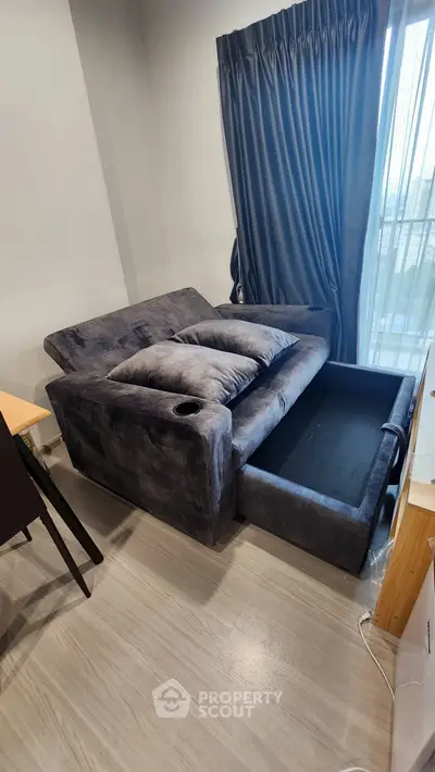 Modern living room with stylish sofa bed and elegant curtains