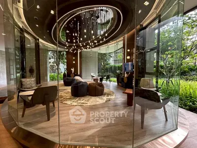 Luxurious modern living room with floor-to-ceiling glass walls and elegant lighting fixtures.