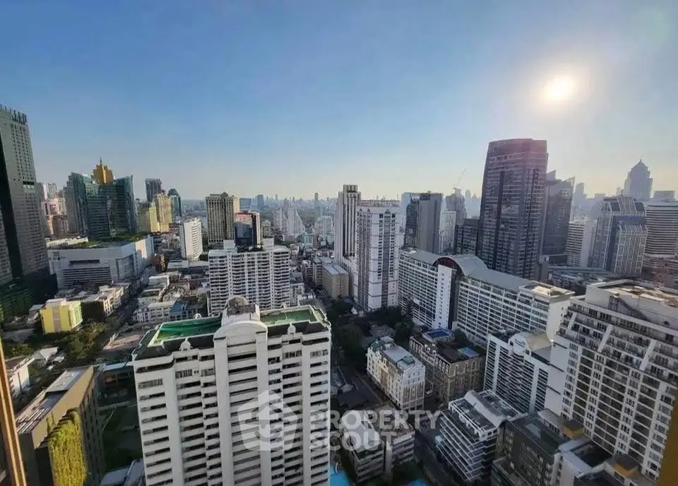 Stunning cityscape view from a high-rise building showcasing urban skyline and architectural diversity.