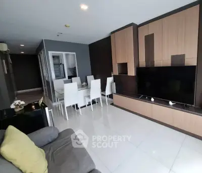 Spacious modern living room with sleek furniture and dining area, perfect for entertaining.