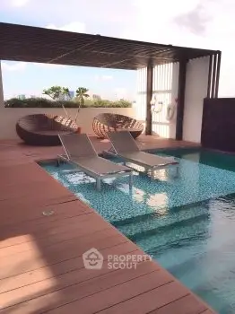 Luxurious rooftop pool with stylish lounge chairs and modern design