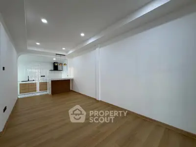 Spacious open-plan living area with modern kitchen and wooden flooring