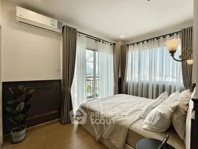 Bright and airy bedroom with large windows and elegant decor