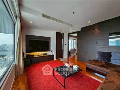 Spacious living room with city view, modern furniture, and red carpet in luxury apartment.