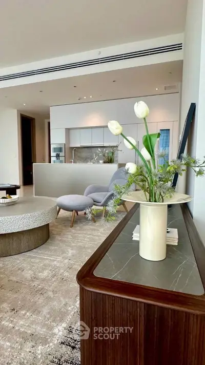 Luxurious open-plan living room with modern kitchen and elegant decor.