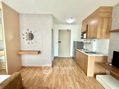 Modern apartment interior with wooden flooring and compact kitchen