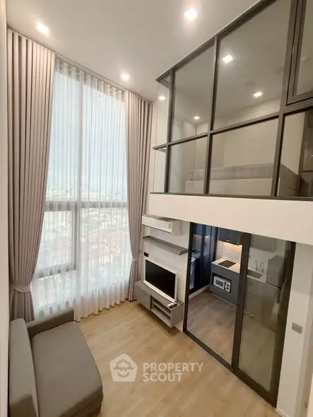 Modern loft apartment with high ceilings and large windows, featuring a cozy living area and stylish mezzanine.